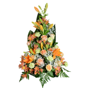 En blombukett arrangerad i en pyramidform med orange liljor, persikofärgade rosor, ljusgröna nejlikor och vit brudslöja, omgiven av gröna blad.